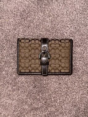 Coach 
 Soho bifold wallet in signature monogram canvas with silver hardware